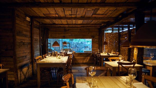 The timber-clad dining room at Mullixhiu, with long wooden tables